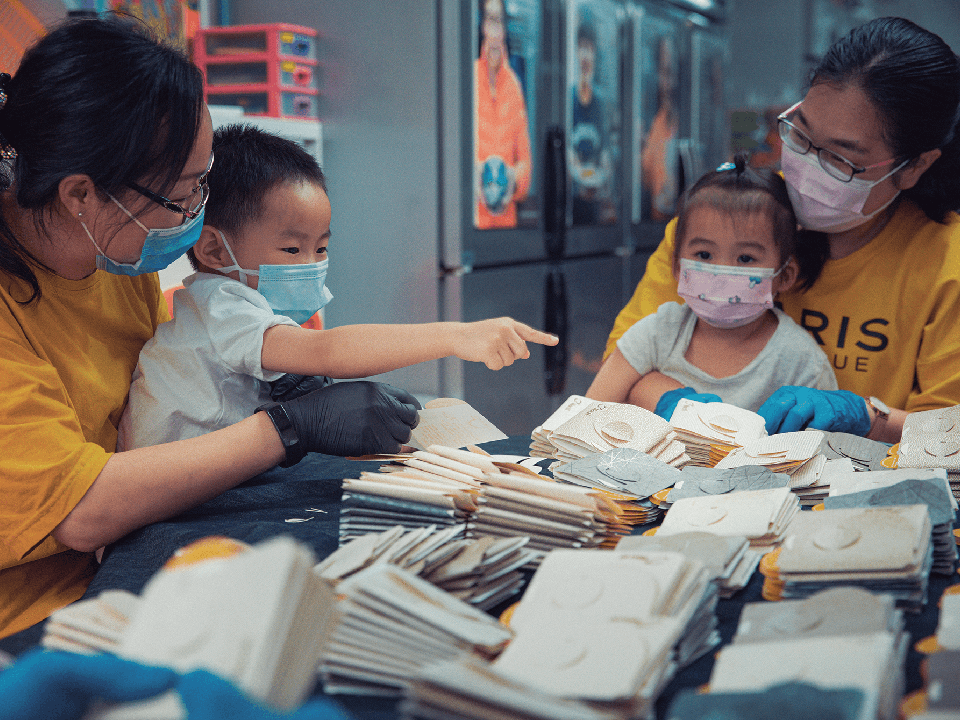 Eco-friendly face mask holders folded by a group of local low-income parents